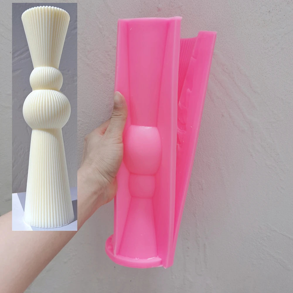 Pink Double Sphere silicone mold beside its matching casting