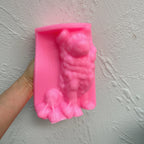 Pink Border Collie silicone candle mold held in one hand