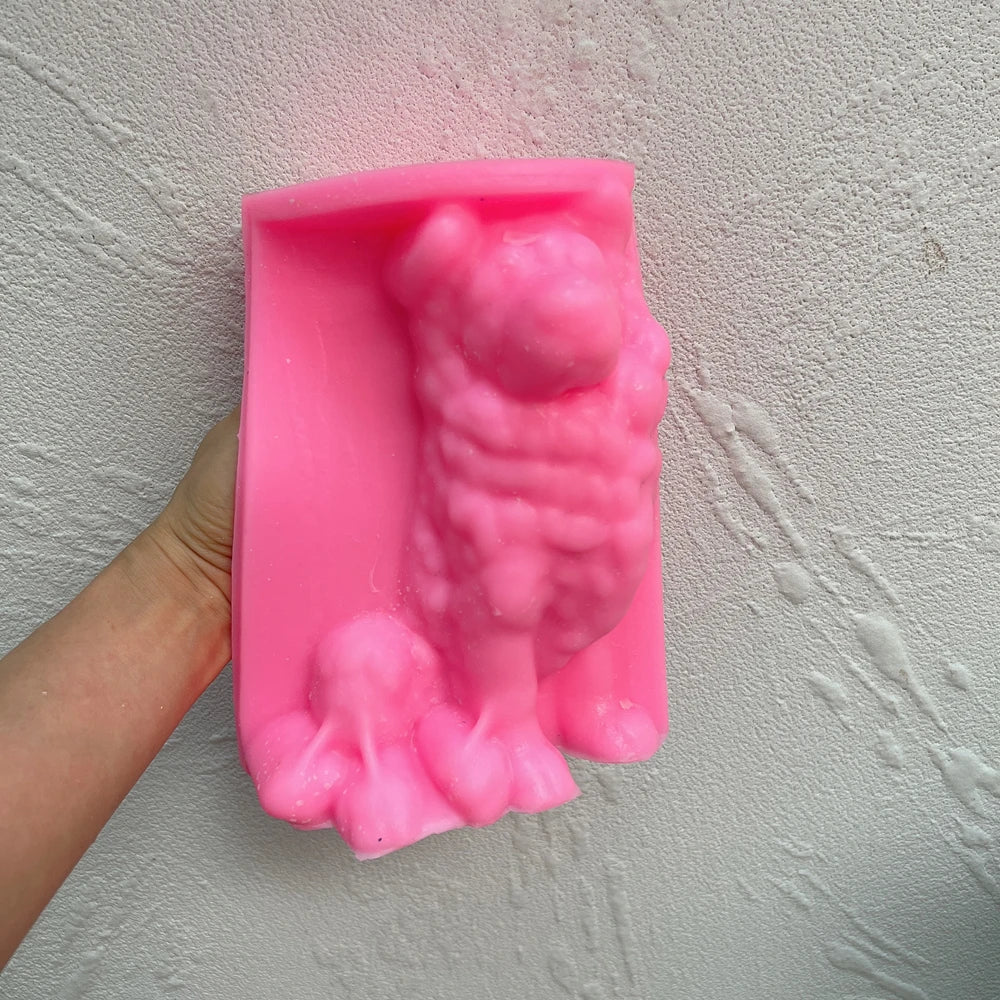 Pink Border Collie silicone candle mold held in one hand