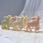 Group of cream and pink standing reindeer candles with branching antlers