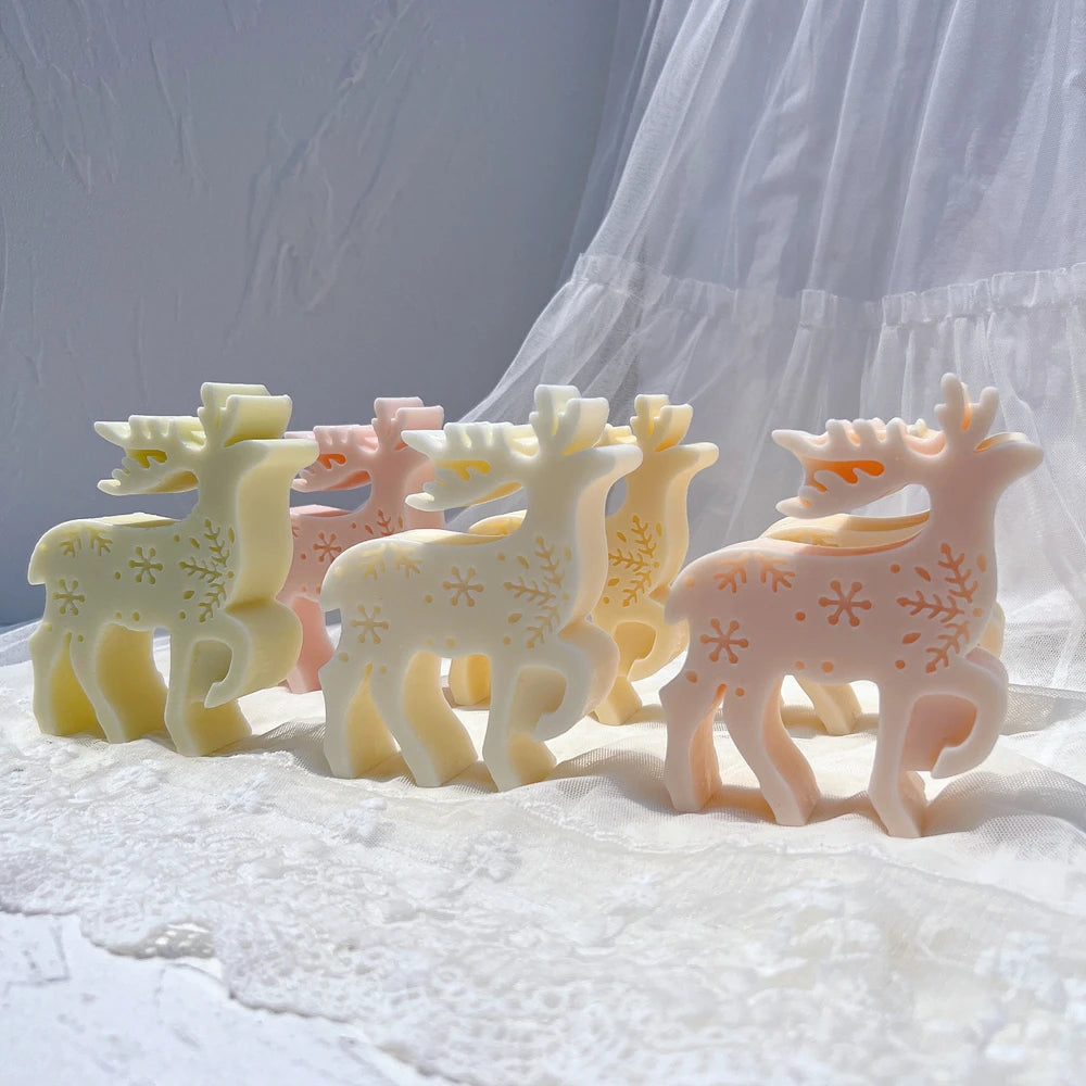 Group of cream and pink standing reindeer candles with branching antlers