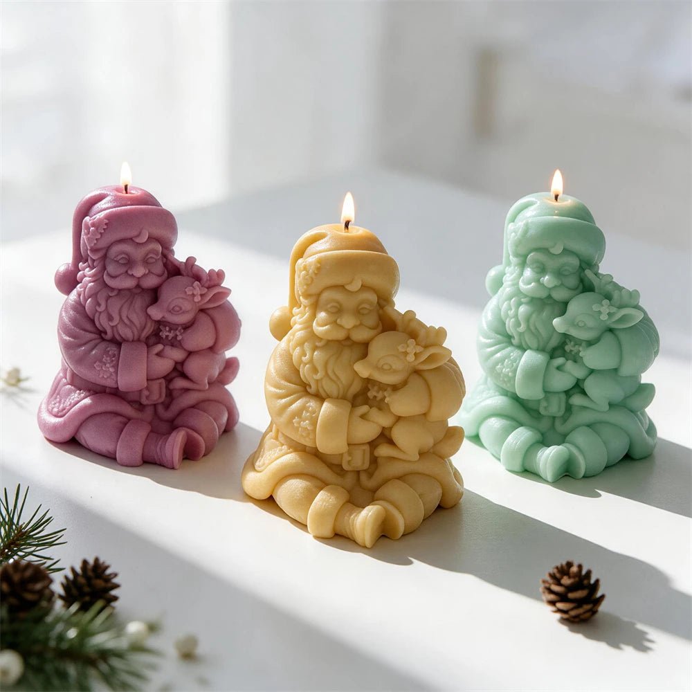 Three Santa and reindeer candle sculptures in pastel colors