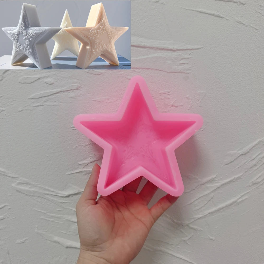 Pink five-point star silicone mold held in one hand with candle examples