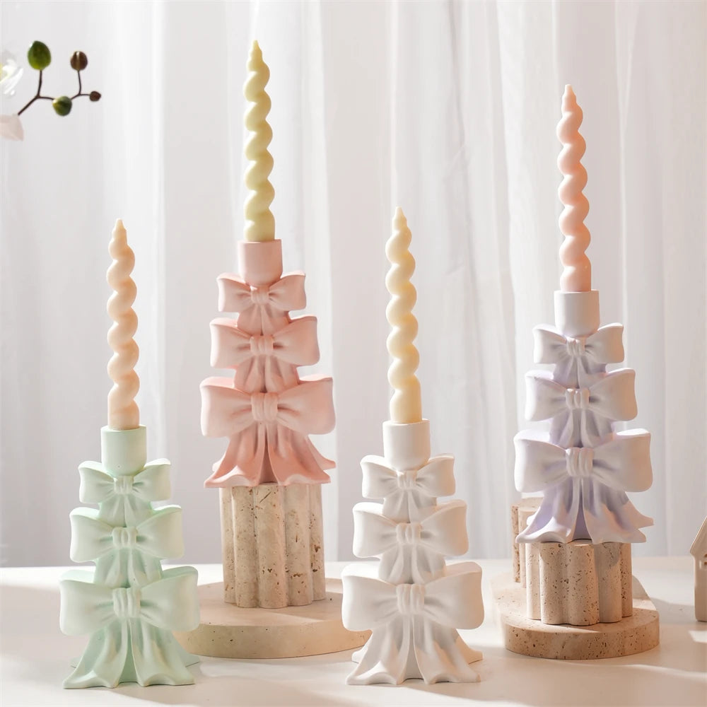 Stacked bow candleholder samples supporting slim spiral candles