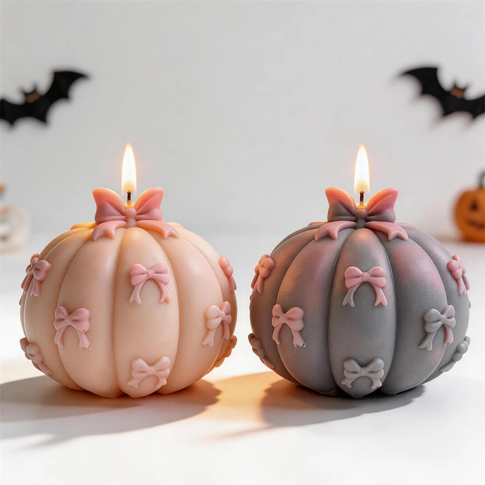 Pink and dark pumpkin candles with raised bow details
