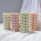 Heart-textured pillar candles in pastel colors displayed upright
