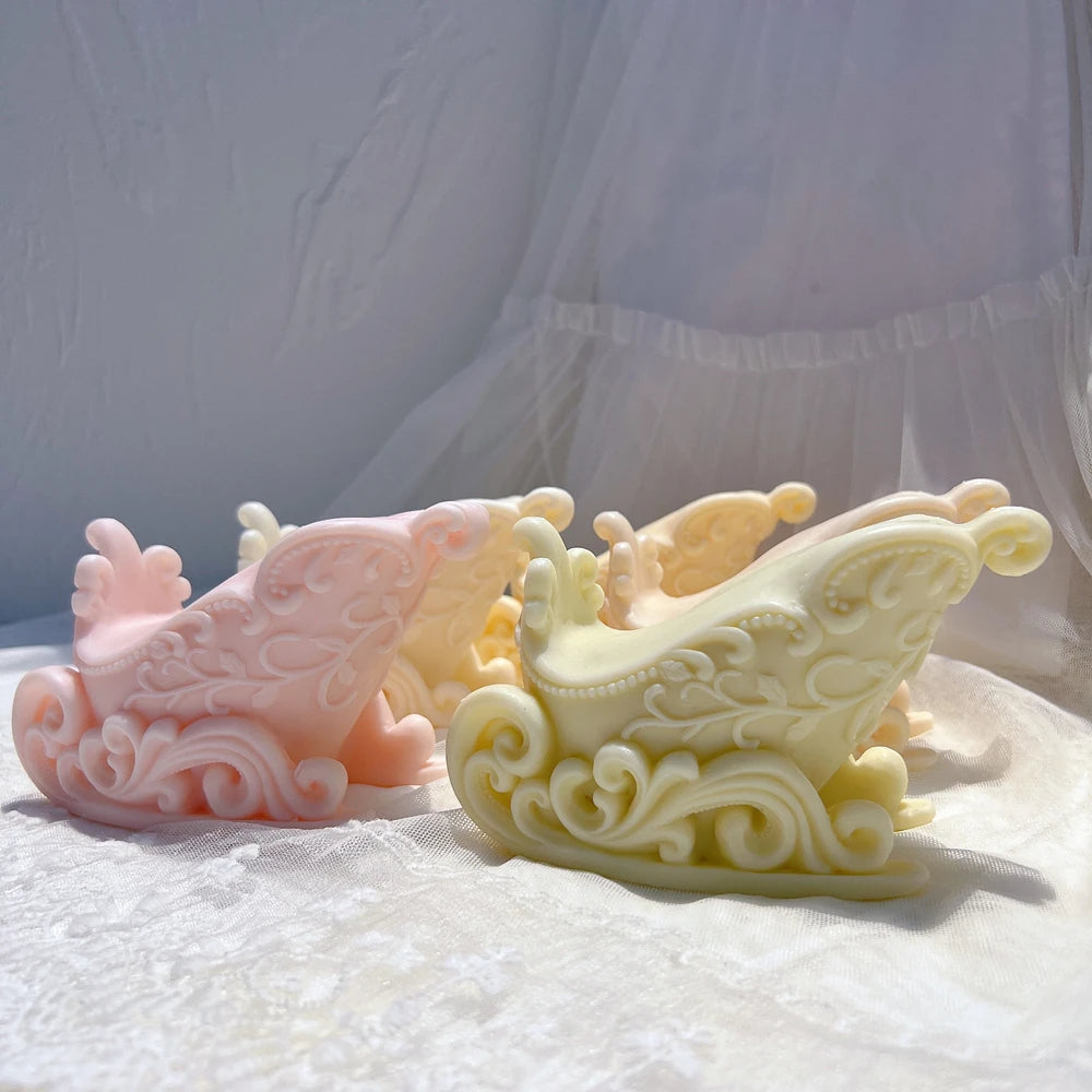 Pink and pale yellow holiday sleigh casting samples with scrolling sides