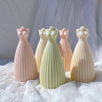 Pink green and ivory gown forms with narrow waists