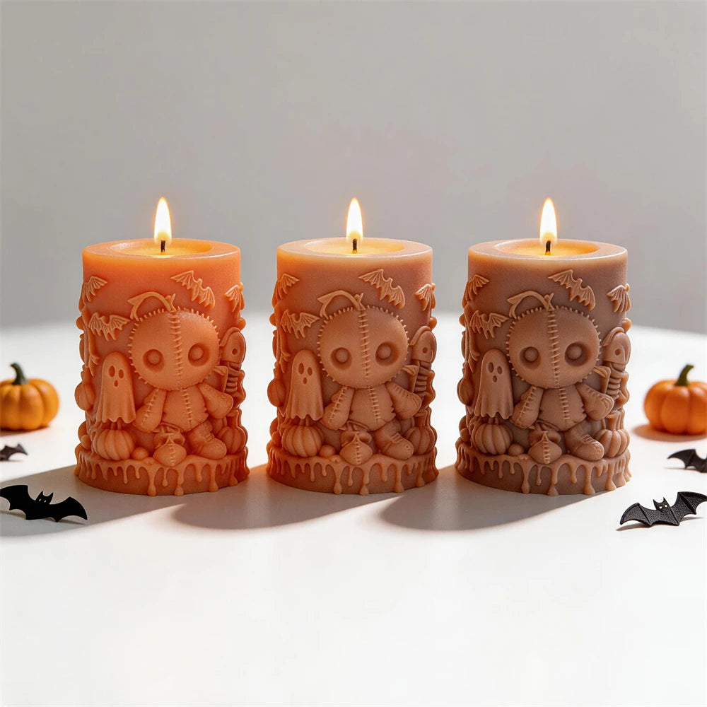 Lit Halloween pillars with stitched doll and ghost relief