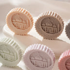 Close-up of raised architectural relief on round medallion candles
