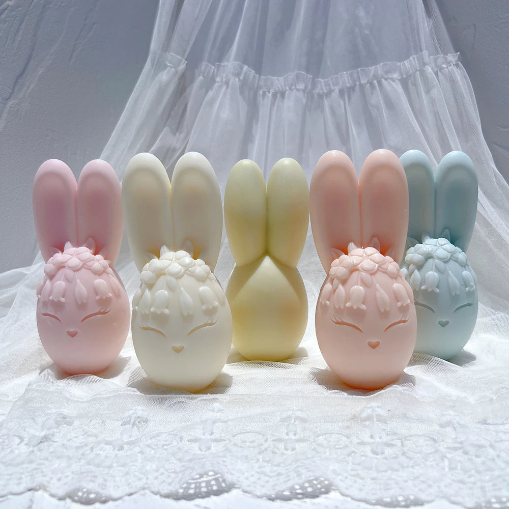 Flower-crowned bunny egg candles with tall ears in pastel colors