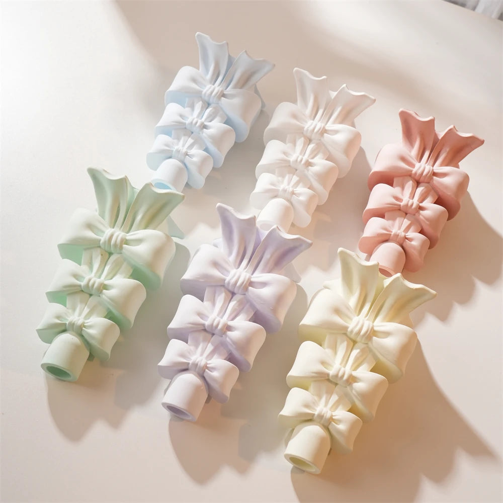 Pastel stacked bow holder samples with graduated ribbon tiers