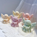 Angled display of praying angels with feathered wings