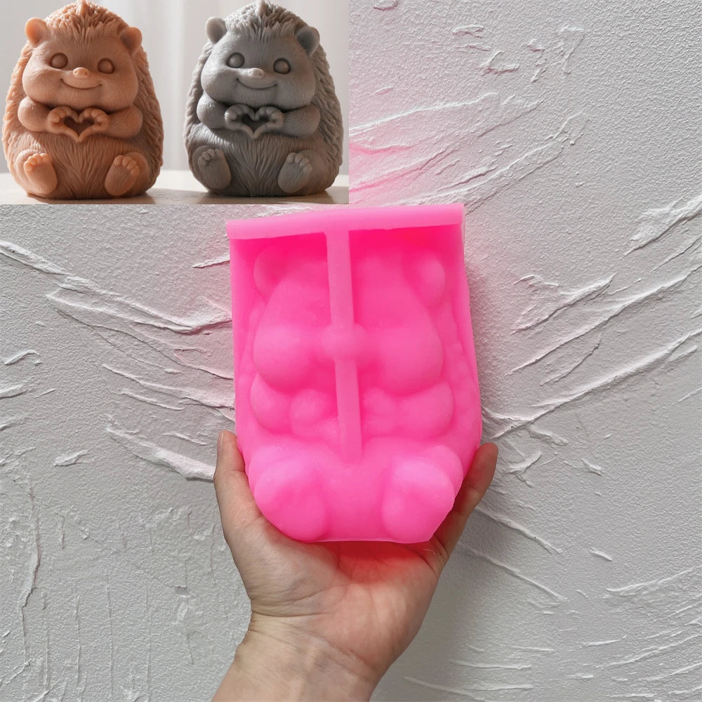 Pink silicone heart-holding hedgehog mold beneath finished examples