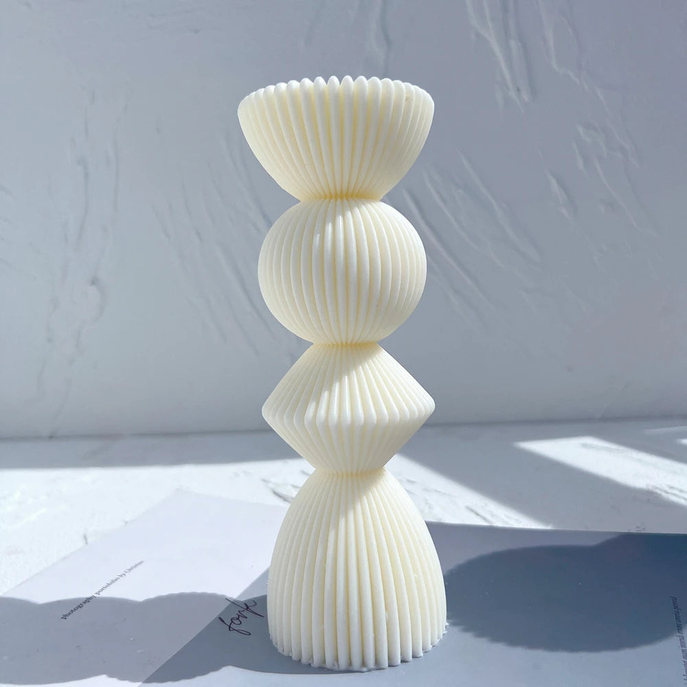 Cream stacked ribbed casting with flared top and rounded center