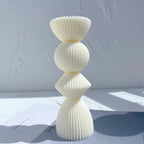 Cream stacked ribbed casting with flared top and rounded center