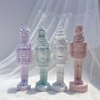 Purple green cream and pink nutcracker figures with contrasting hat styles