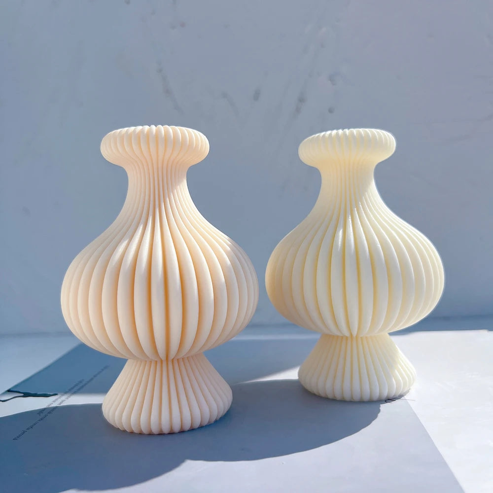 Two short rounded ribbed figures with flared necks