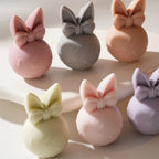 Overhead view of pastel egg bunnies with bows