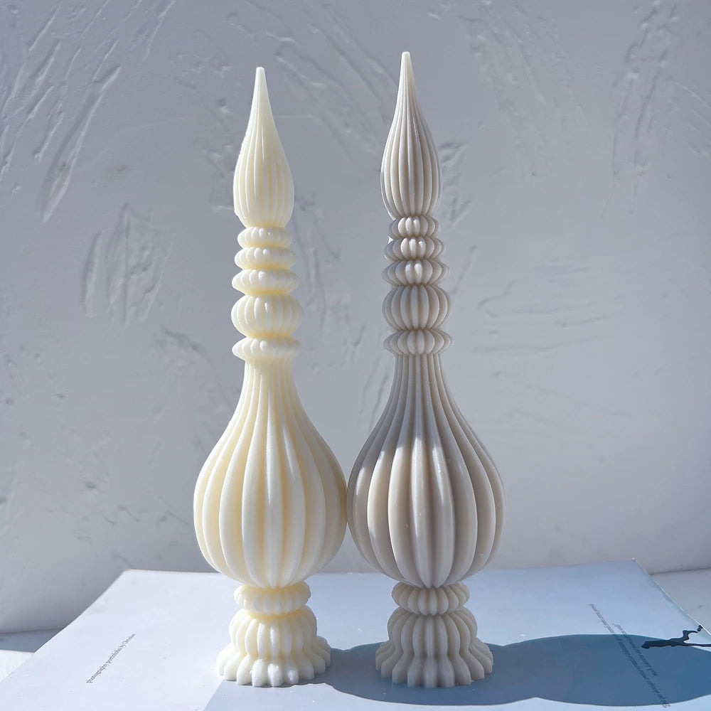 Cream and gray finial samples side by side on a blue surface