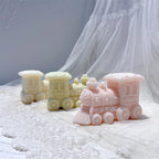 Cream yellow and pink locomotive figures with sculpted wheels