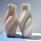 Angled pair of twisted pillars with flowing surface ribs