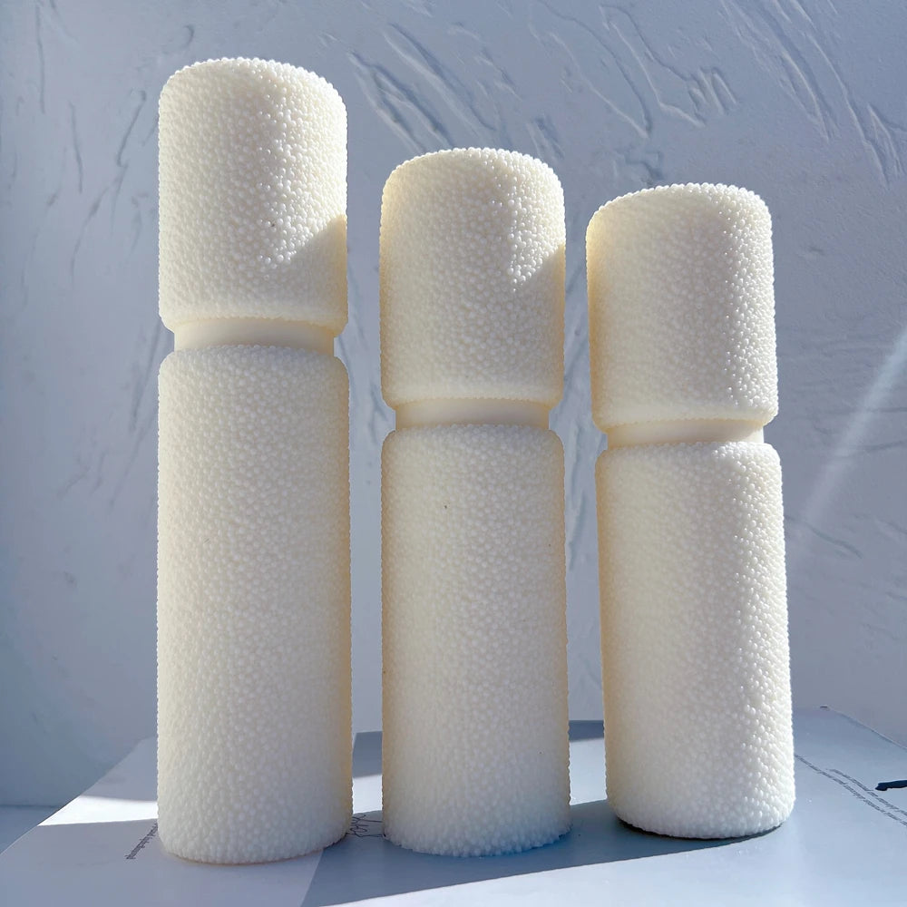 Cream waisted pillar castings with fine pebble-textured surfaces