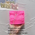 Pink gingerbread bow silicone mold with marked pin placement and included-pin guidance