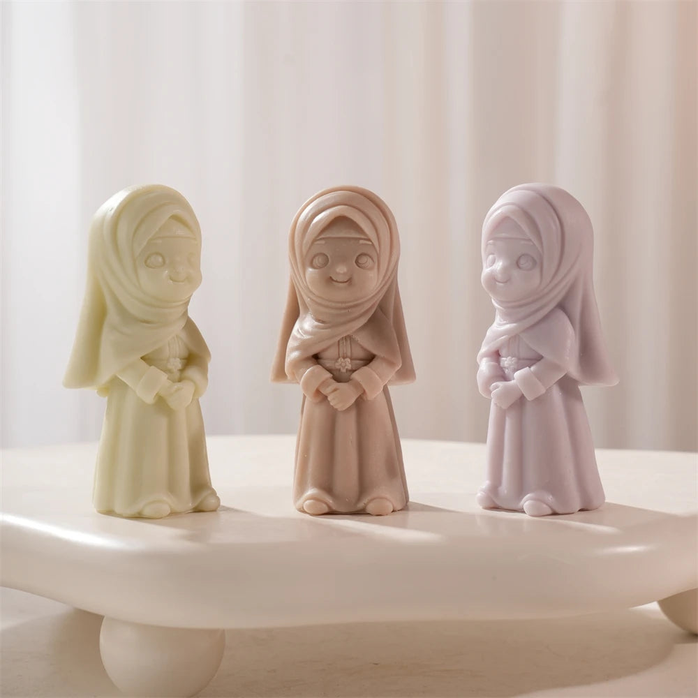 Three headscarf girl candle castings in long dresses