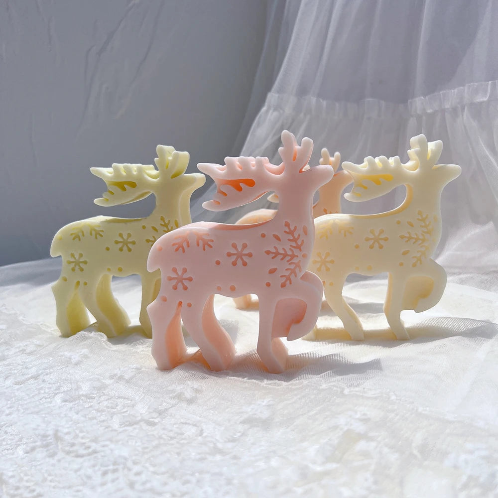 Cream and pink standing reindeer castings with snowflake flank patterns and branched antlers
