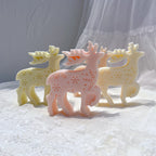 Cream and pink standing reindeer castings with snowflake flank patterns and branched antlers