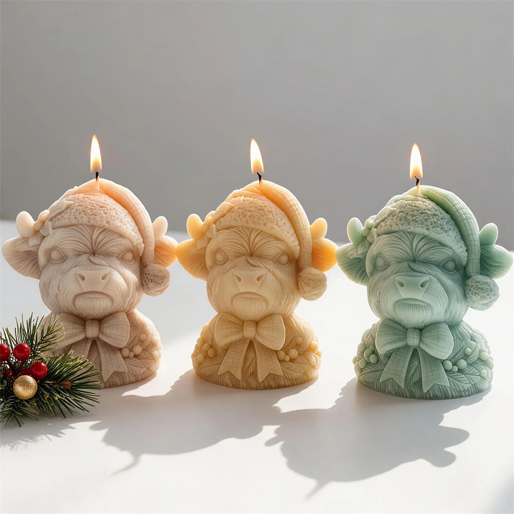 Santa-hat Highland cow candle busts with neck bows