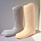 Two cowboy boot castings showing pointed toes and raised decoration