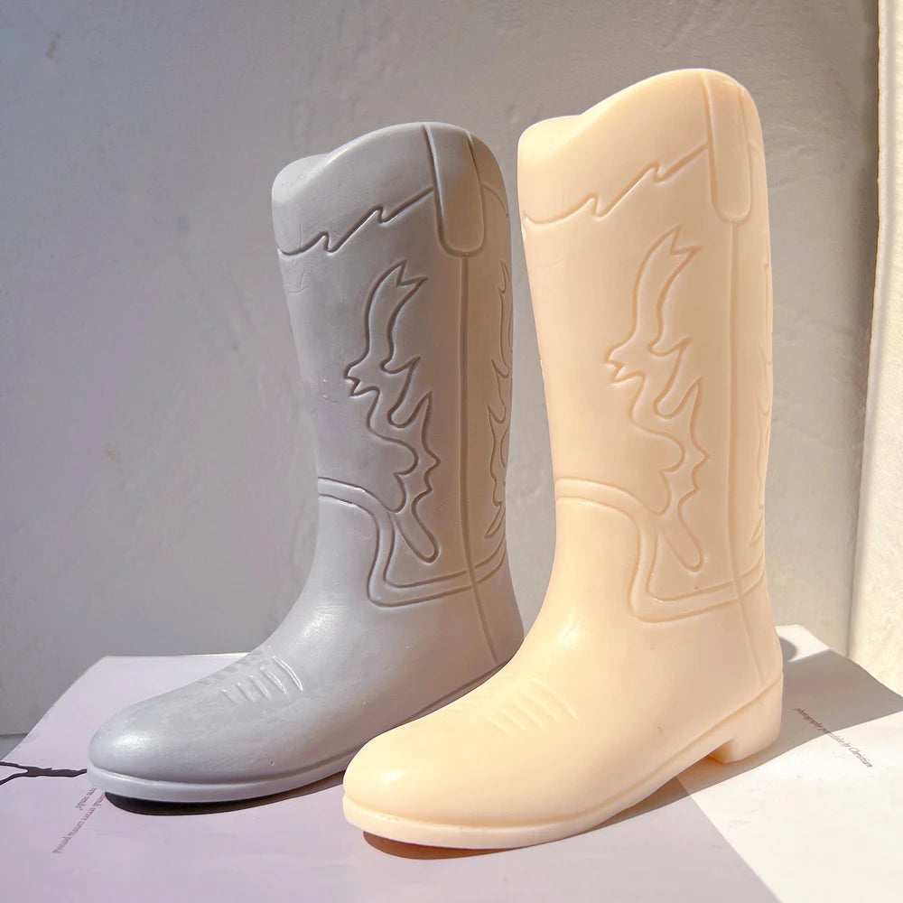 Two cowboy boot castings showing pointed toes and raised decoration