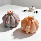 Two pumpkin castings with small ribbon bows across their lobes