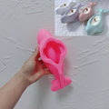 Pink silicone casting mold for beluga whale with sculpted recess