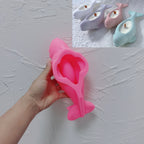Pink silicone casting mold for beluga whale with sculpted recess
