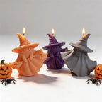 Three Halloween witch ghost candles beside pumpkin decorations