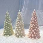 Three individually cast droplet-branch Christmas trees displayed on fabric