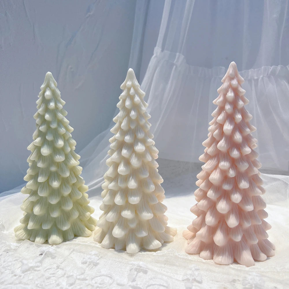 Three individually cast droplet-branch Christmas trees displayed on fabric