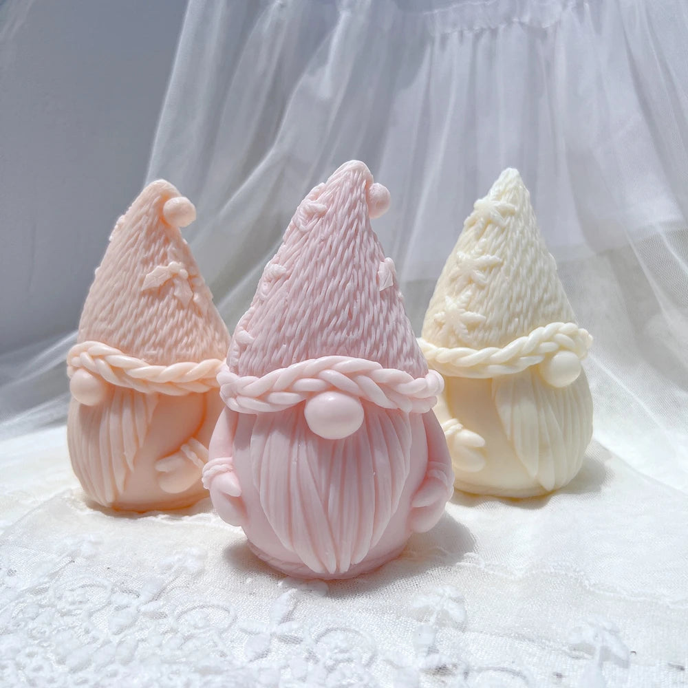 Peach pink and cream gnome figures with tall cone hats