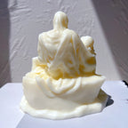 Rear view of the seated figure's robe and sculptural base