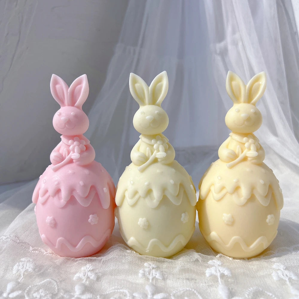 Flower-holding bunnies above floral eggs with wavy trim