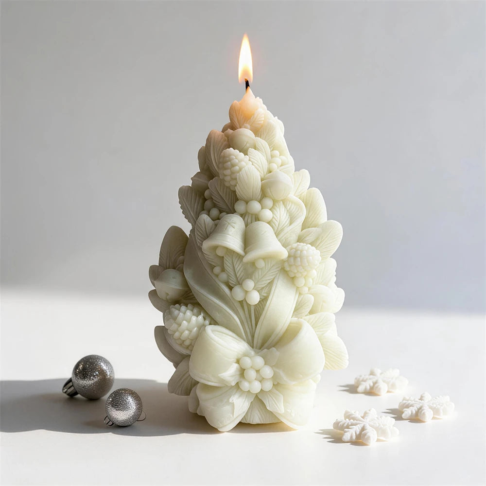 Cream pinecone candle showing its raised bell, bow and berry motifs
