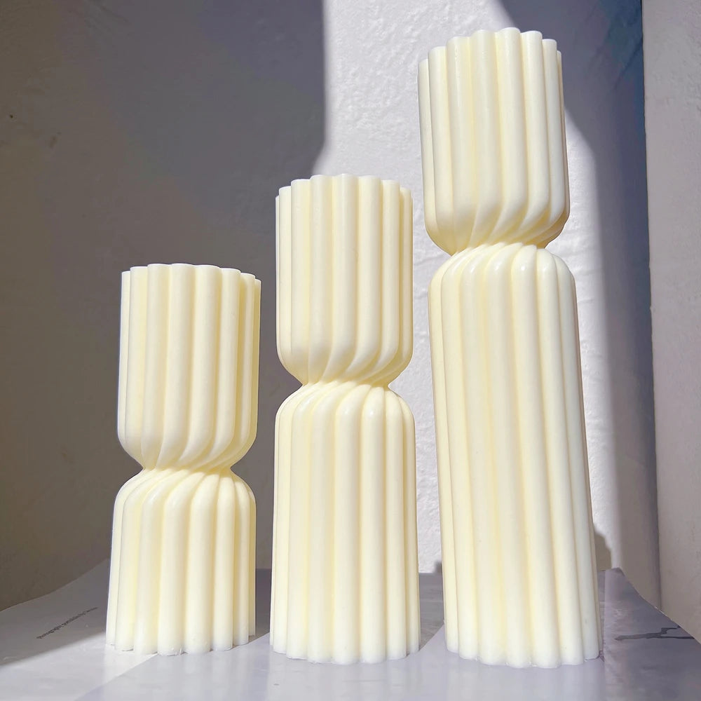 Two stacked-ribbed sculptural candle sections with pinched waists