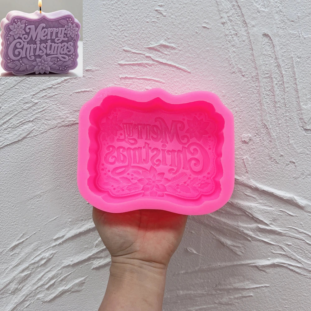 Pink silicone mold with recessed Merry Christmas lettering and floral frame
