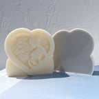 Decorated pregnancy relief beside a plain reverse