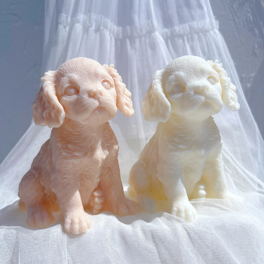 Front view of two puppy castings with rounded paws and small muzzles