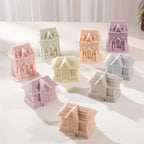Arrangement of gingerbread house candles with roof tiles and windows