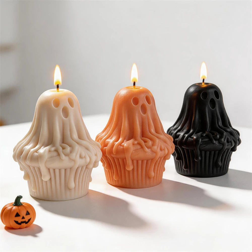 Cream, orange and black ghost figures on fluted cupcake bases